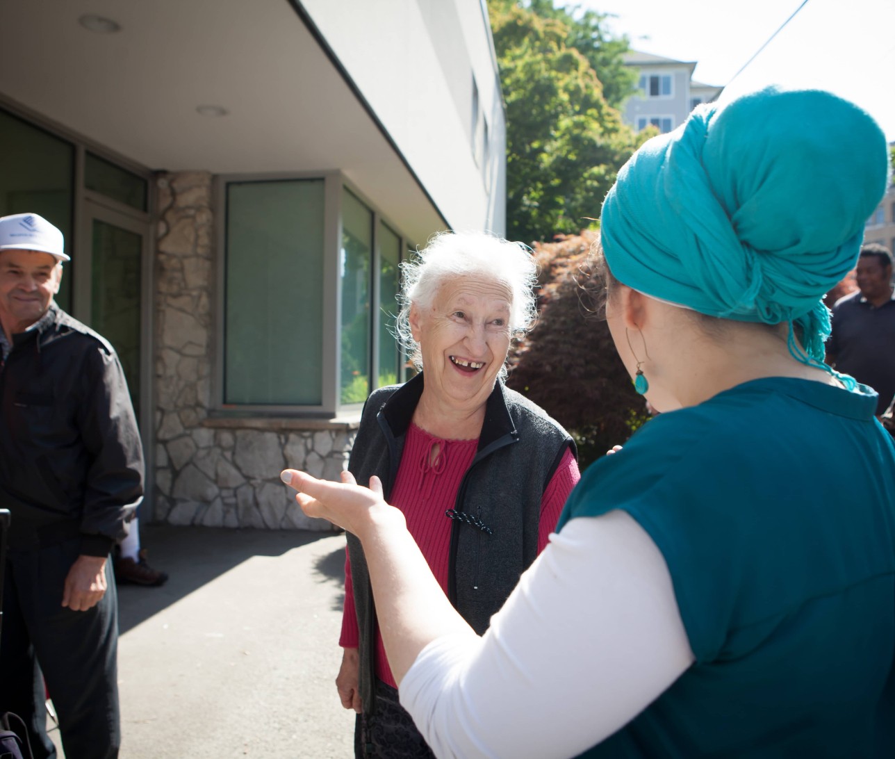 Woman laughing an dtalking to an older woman