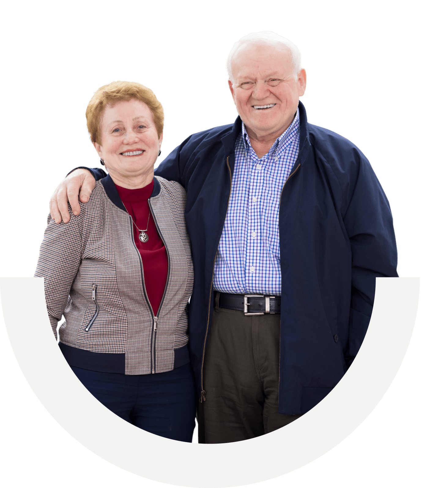 Cut out of older husband and wife standing smiling for a photo. Husband's arm around the wife.