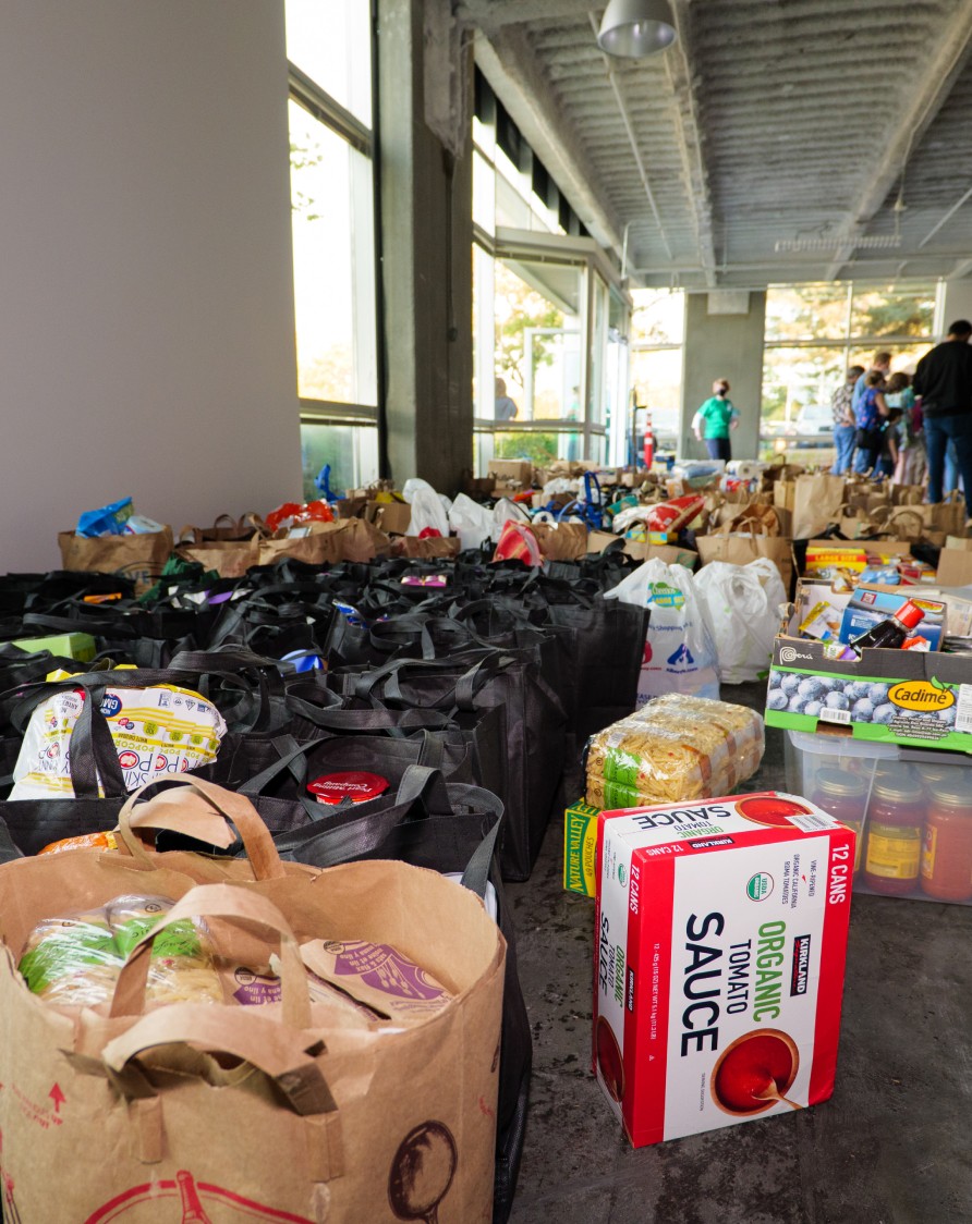 Large amount of donated food in crates, boxes, and bags