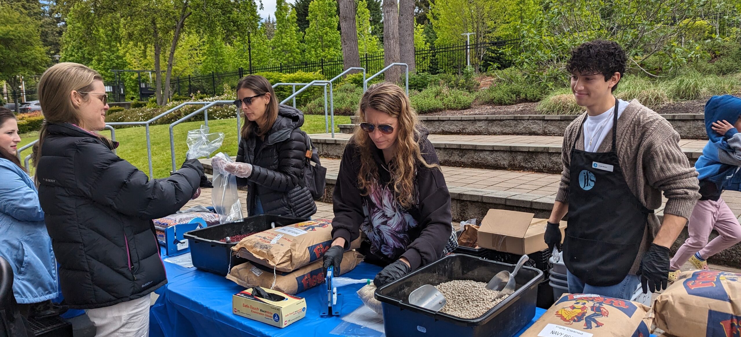 Volunteers serving others at a blue table