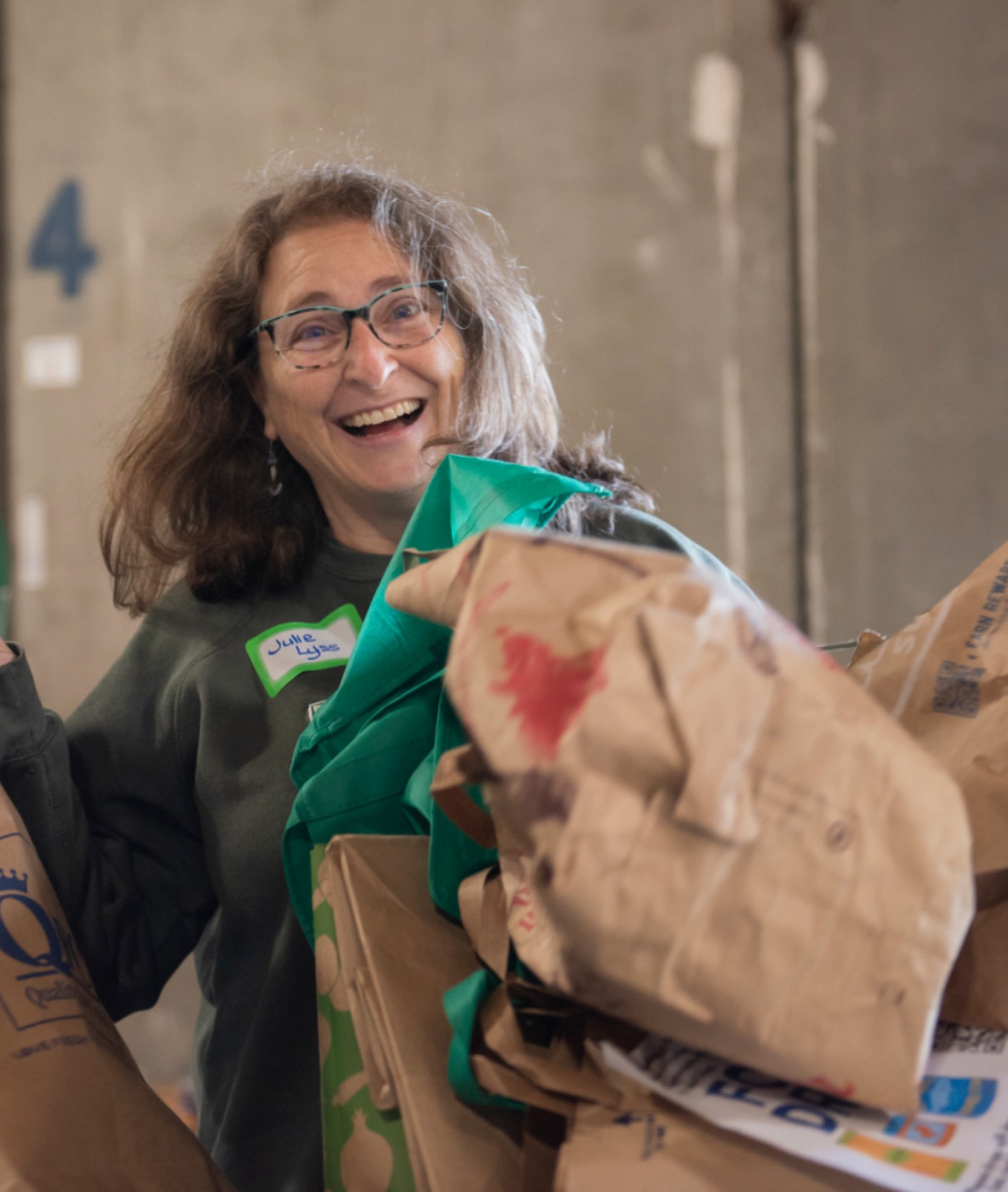 Young woman smiling with bags in front of her