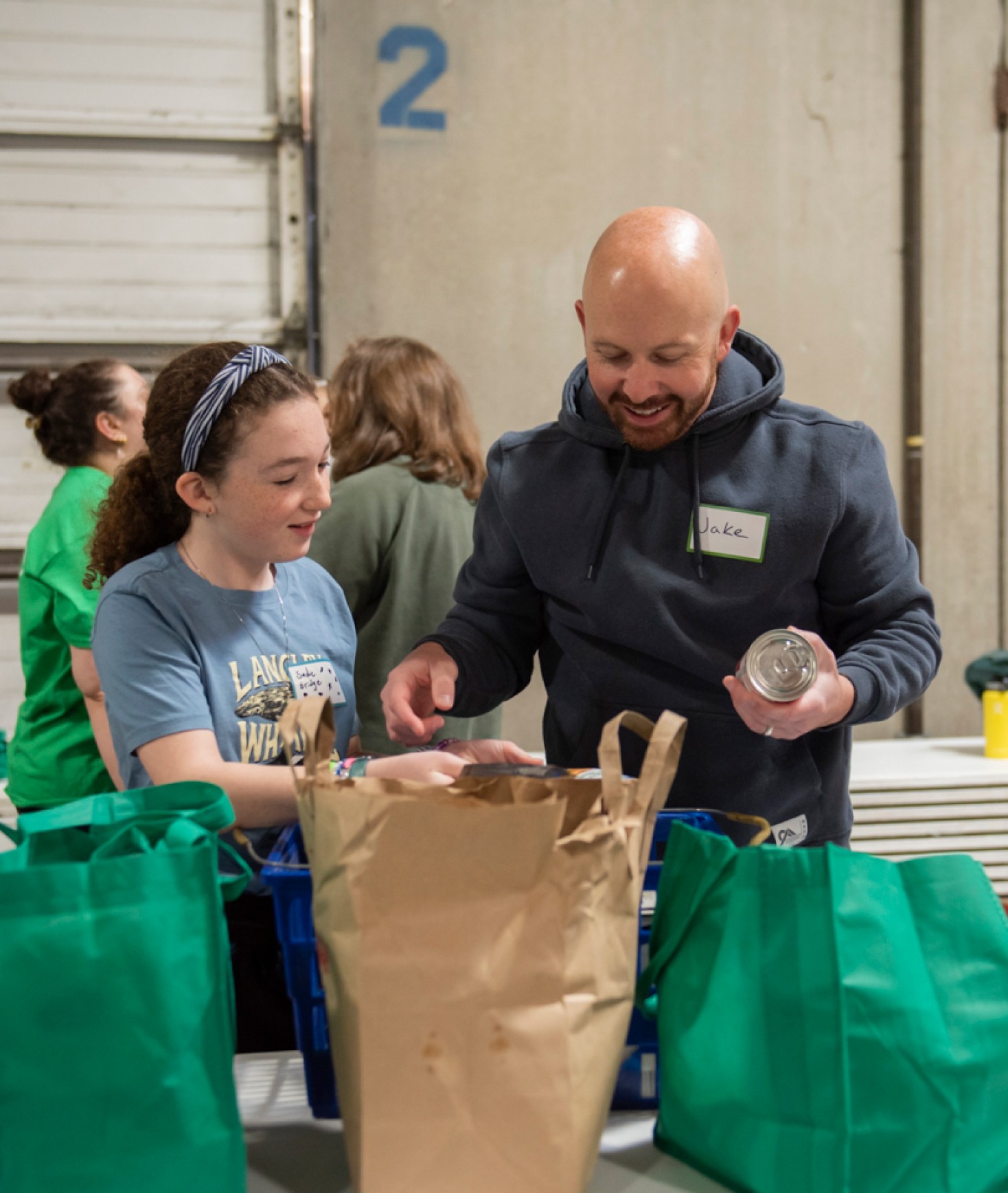 Man helping young girl sort food
