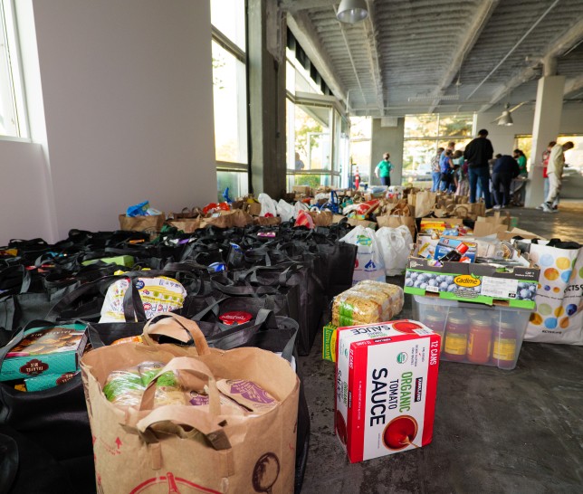Large amount of donated food in crates, boxes, and bags