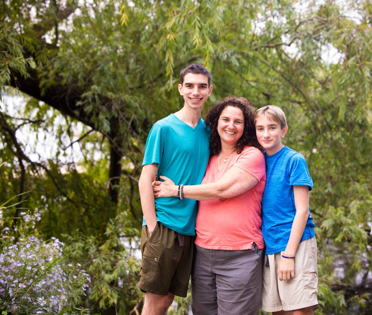 Mother taking a picture with her two teenage sons