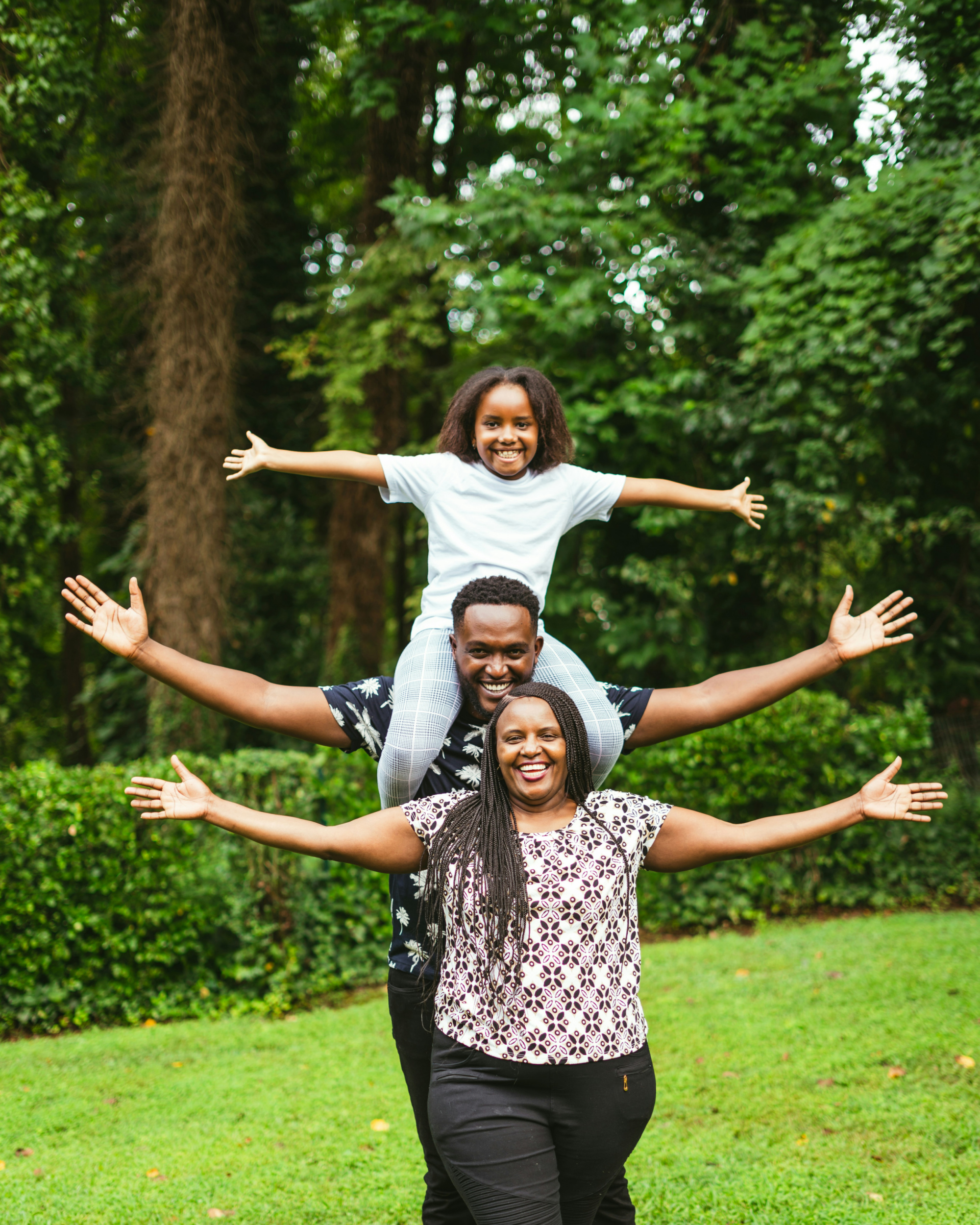Family outside with their daughter on the father's shoulders