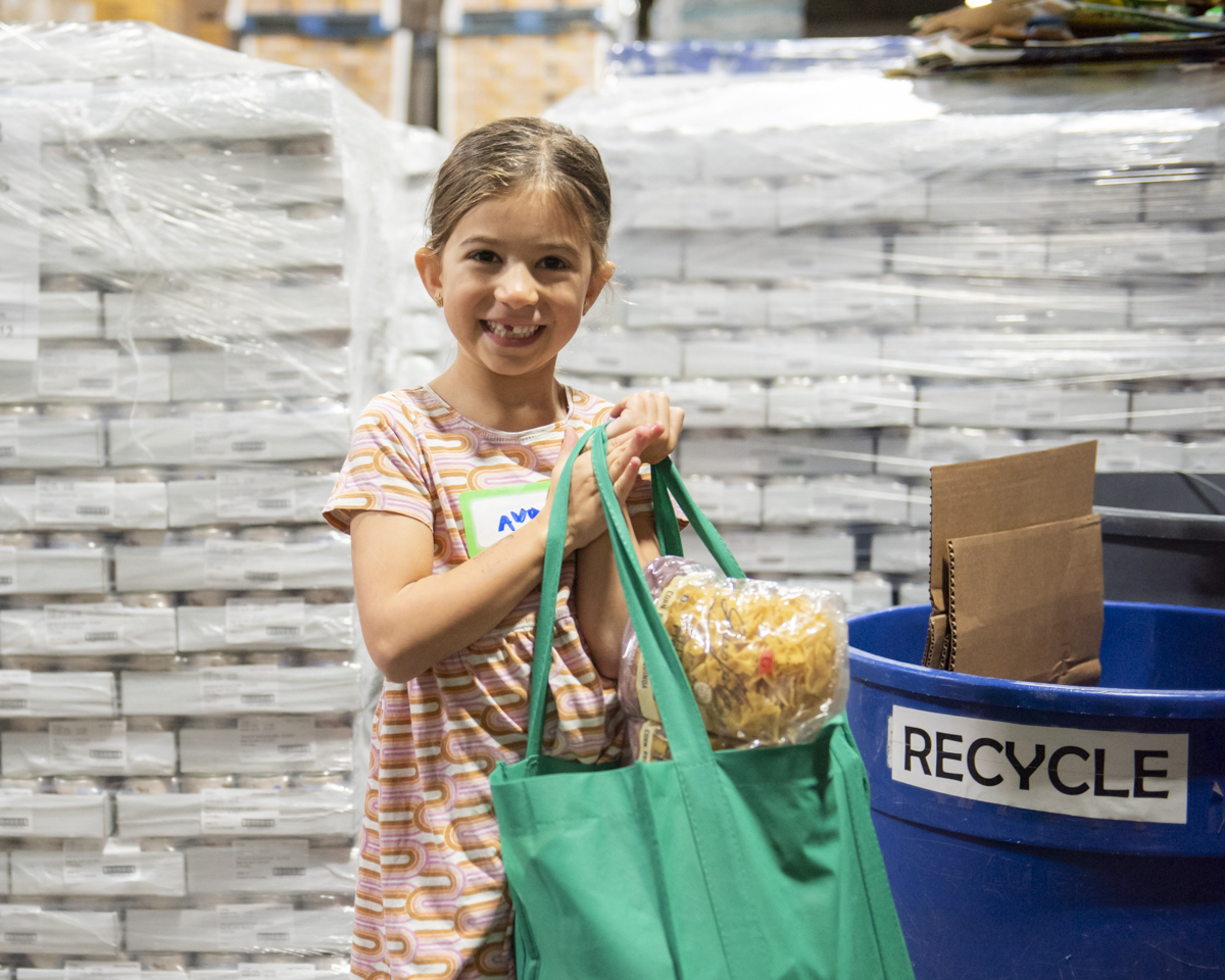 Young girl at food sort volunteer event