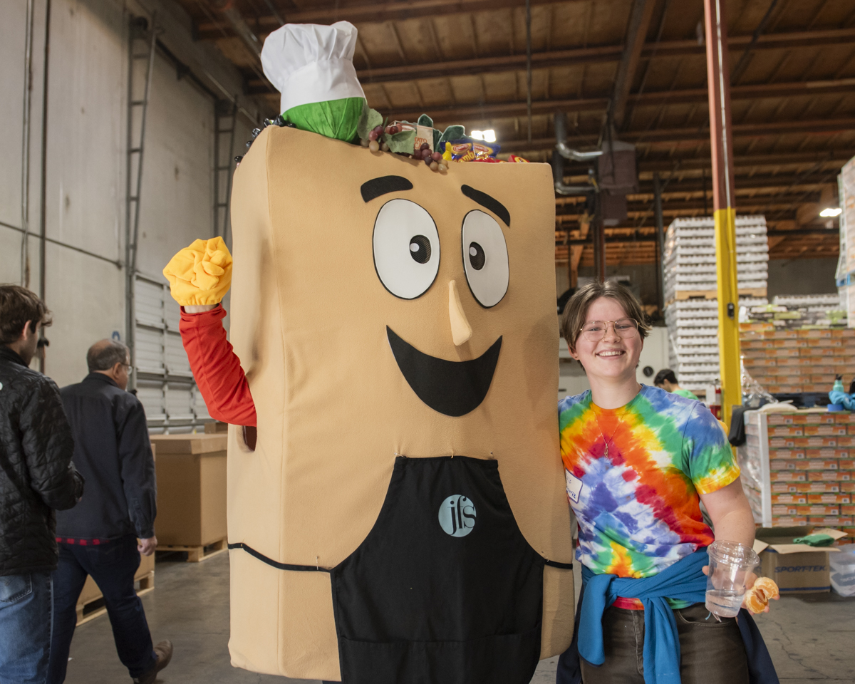 JFS food sort mascot with a volunteer