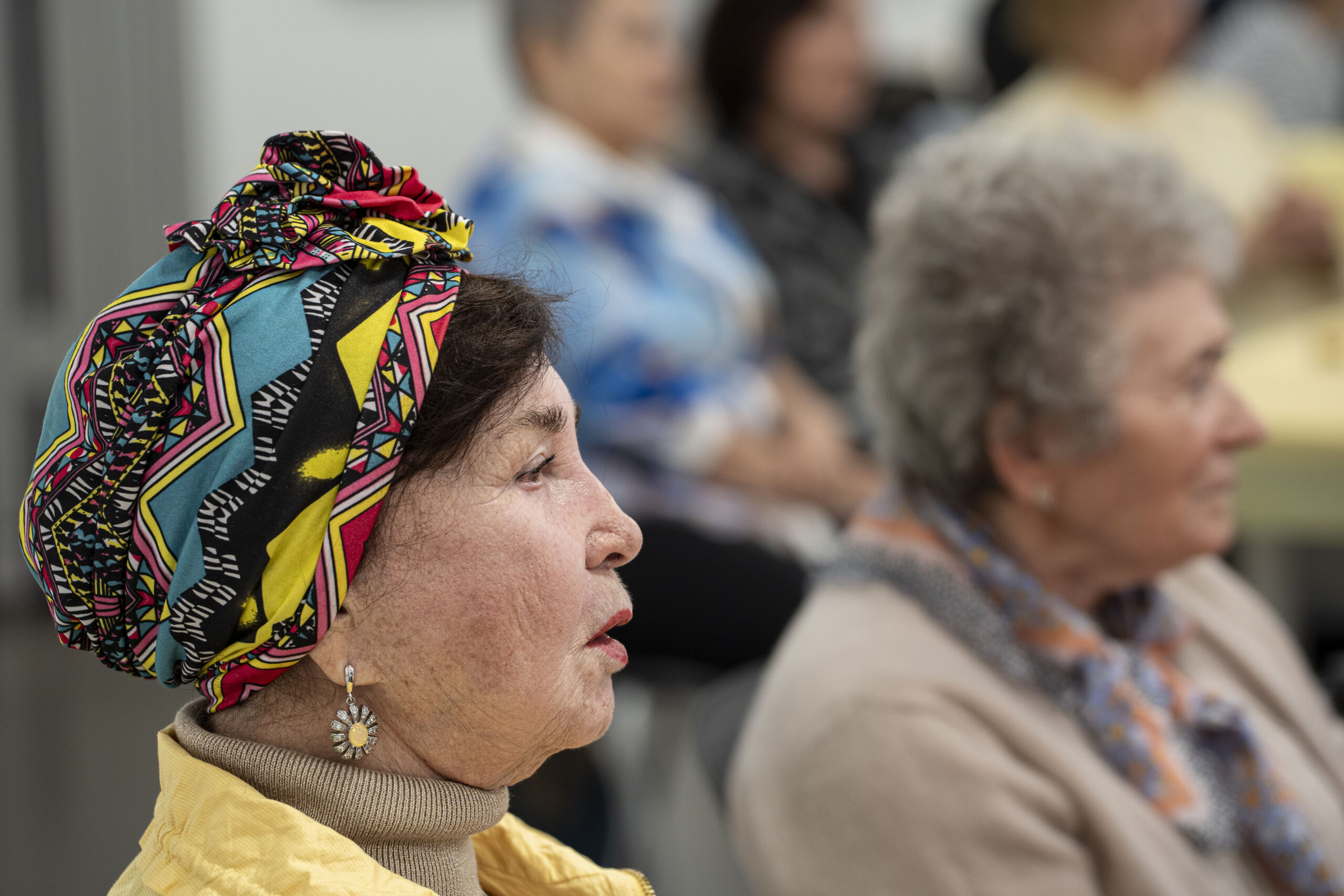 older woman in a brightly-colored headscarf