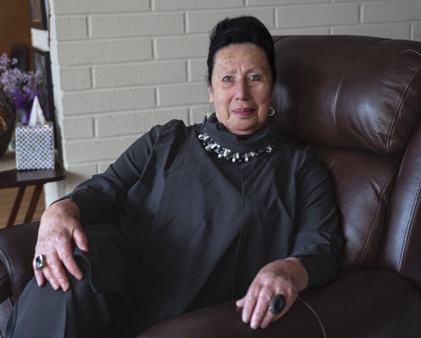 Holocaust Survivor (older woman in a black dress)