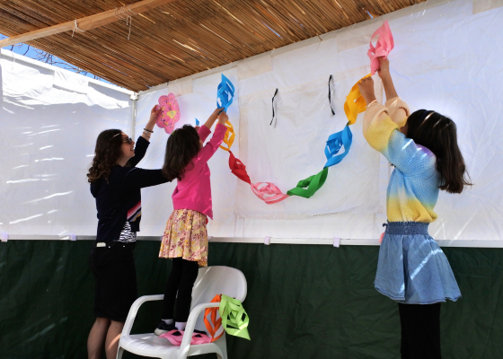 three girls hanging up decorations
