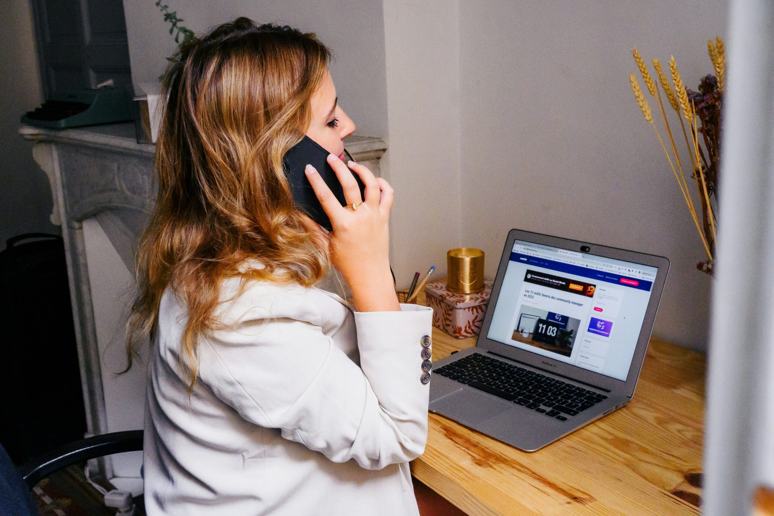 woman on the phone in front of a computer