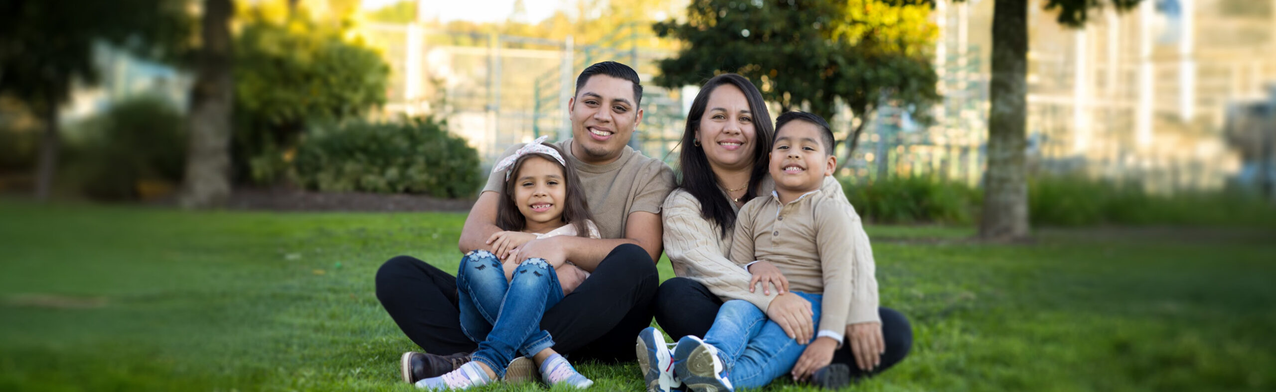 immigrant family portrait sitting outside in a park