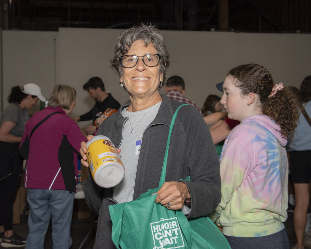 Woman putting food in a bag at the Food Sort