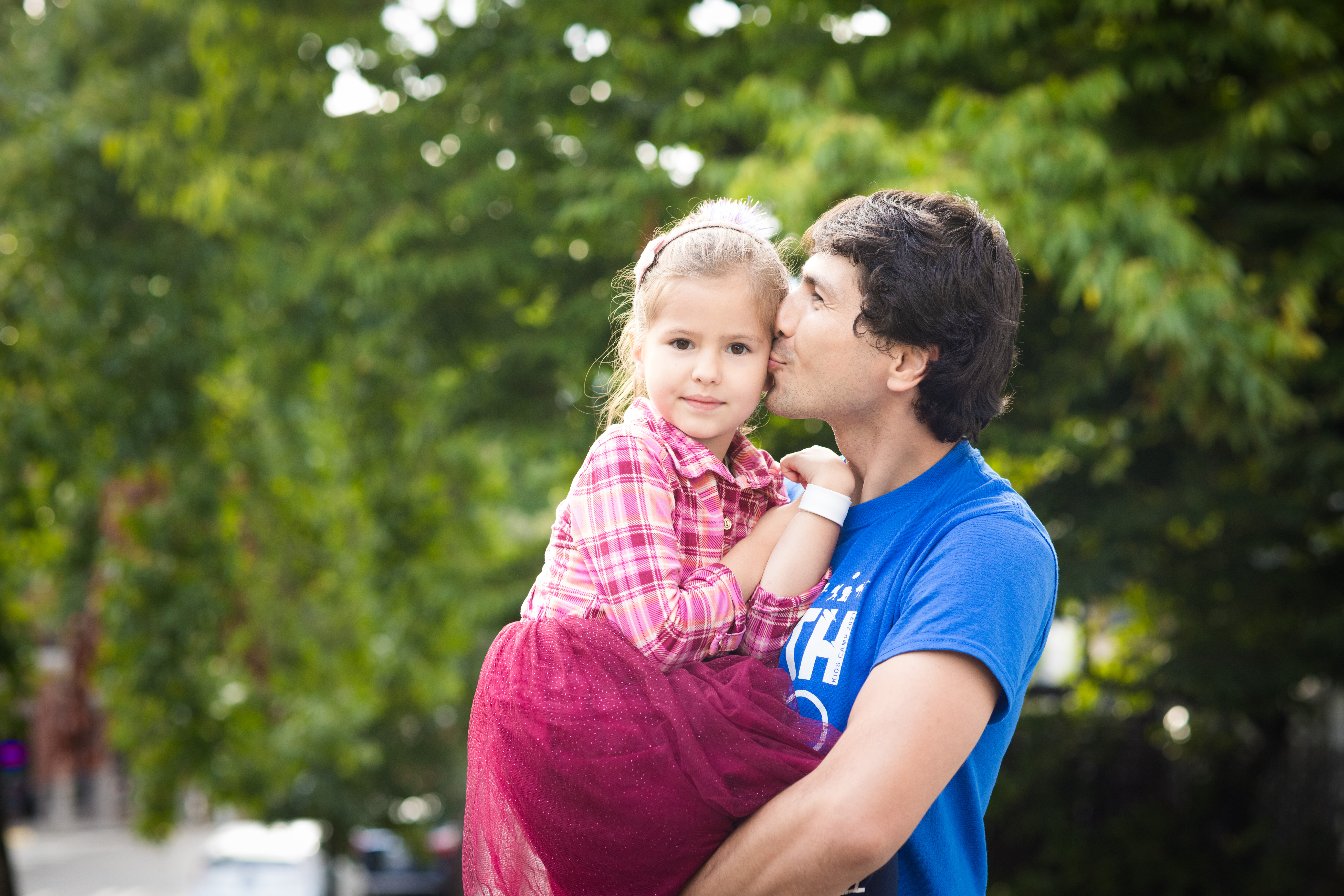 Father kissing young daughter's cheek