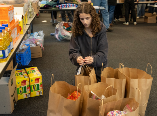 girl adding food to bags