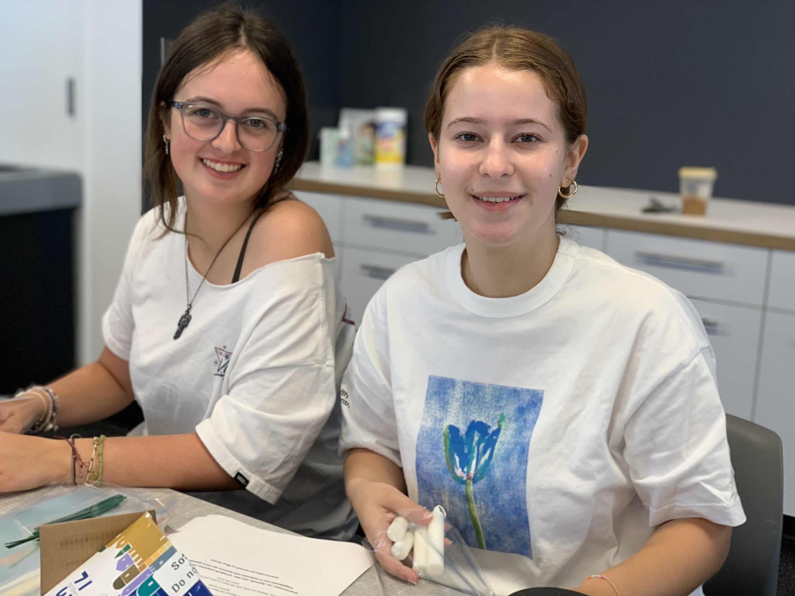 two girls filling bags for Rosh Hashana