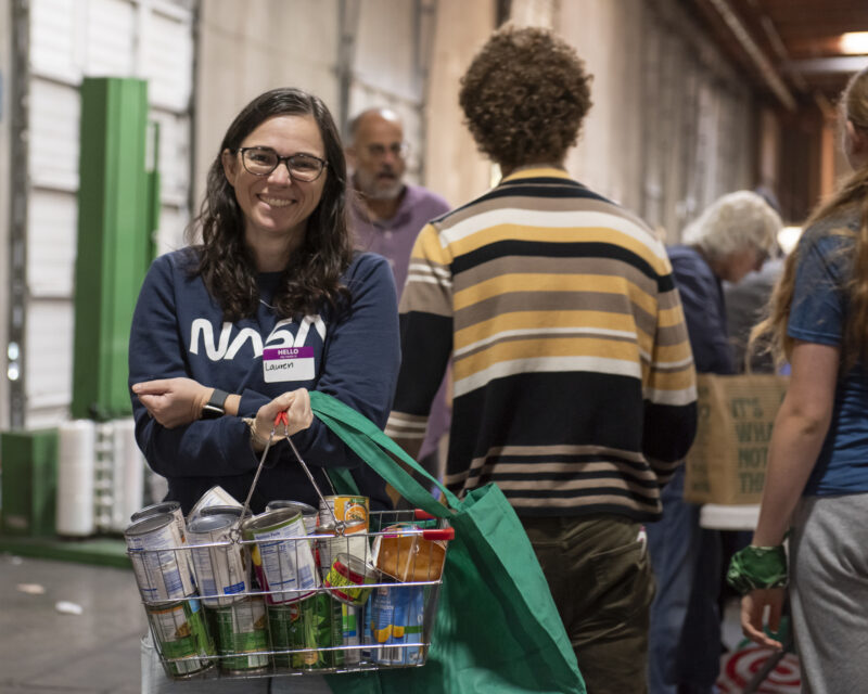smiling woman, volunteering at the Food Sort